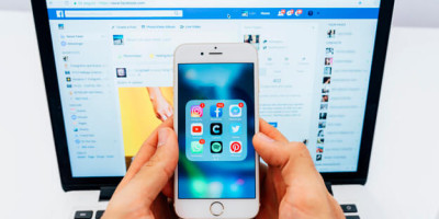 phone-with-apps-and-laptop-with-facebook_23-2147651275
