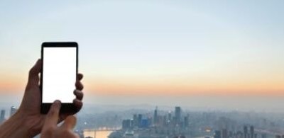 hand-touching-a-mobile-screen-with-city-background_1112-855 (1)